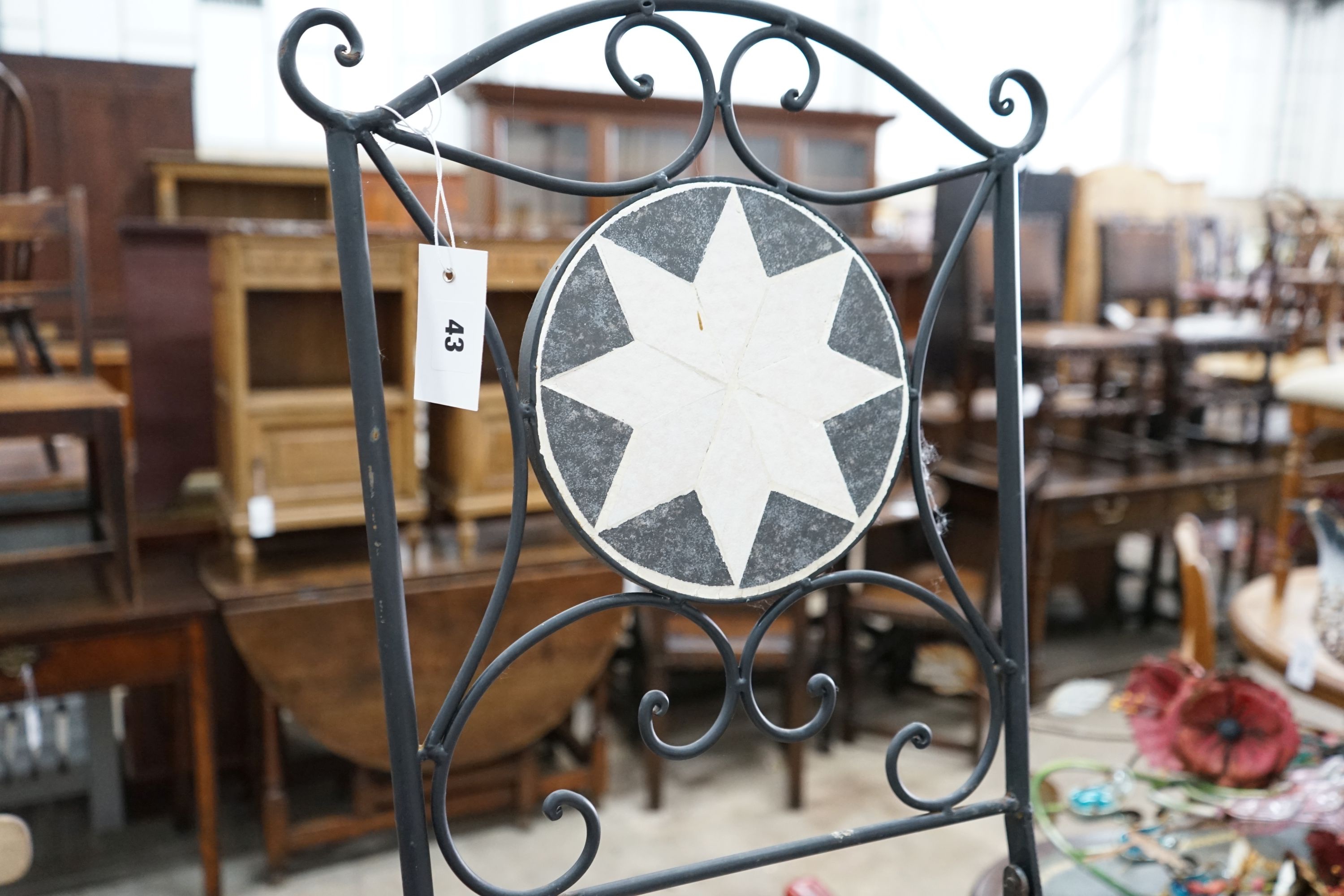 A wrought iron mosaic top circular bistro table, diameter 60cm, height 70cm together with a pair of folding chairs